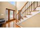 Inviting foyer featuring hardwood floors, a staircase, and a decorative glass front door at 924 Evian Nw Dr, Kennesaw, GA 30152