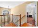 Upstairs hallway features a window and wrought iron banister at 924 Evian Nw Dr, Kennesaw, GA 30152