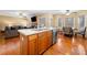 Kitchen island featuring wooden cabinets, stainless appliances, hardwood floors and an adjacent eat-in kitchen and living room at 924 Evian Nw Dr, Kennesaw, GA 30152