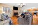 Cozy living room with fireplace, hardwood floors, and open layout with views into kitchen at 924 Evian Nw Dr, Kennesaw, GA 30152