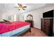 Carpeted main bedroom featuring a bed, large dresser, TV, and a window with bright natural light at 924 Evian Nw Dr, Kennesaw, GA 30152