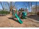 Community playground featuring a green slide, climbing structure, and wood chip ground cover at 924 Evian Nw Dr, Kennesaw, GA 30152