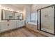 A bathroom featuring a double vanity, soaking tub, and glass-enclosed shower at 167 Pinewood Dr, Covington, GA 30014