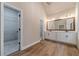 A bathroom featuring a double vanity with modern fixtures and a walk-in closet at 167 Pinewood Dr, Covington, GA 30014