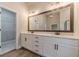 A bathroom featuring a double vanity with modern fixtures and a walk-in closet at 167 Pinewood Dr, Covington, GA 30014
