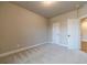 Neutral bedroom featuring light carpet and a window that provides natural light at 167 Pinewood Dr, Covington, GA 30014