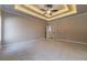 A spacious bedroom featuring a tray ceiling with recessed lighting and neutral walls at 167 Pinewood Dr, Covington, GA 30014