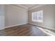 Cozy bedroom featuring hardwood floors, neutral walls, and a bright window view at 167 Pinewood Dr, Covington, GA 30014