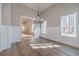 Sunlit dining room featuring hardwood floors, elegant lighting, and scenic outdoor views at 167 Pinewood Dr, Covington, GA 30014