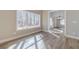 Sunlit dining area features wood-look flooring, large window and modern chandelier at 167 Pinewood Dr, Covington, GA 30014