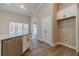 Well-lit kitchen featuring white cabinetry and stainless steel dishwasher, complemented by wood-look floors at 167 Pinewood Dr, Covington, GA 30014