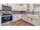 Well-equipped kitchen with stainless steel appliances, white cabinetry and modern finishes at 167 Pinewood Dr, Covington, GA 30014