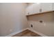 Bright laundry room featuring wood-look flooring and white cabinets above washer/dryer hookups at 167 Pinewood Dr, Covington, GA 30014