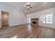 Spacious living room with vaulted ceiling, wood-look floors and a cozy brick fireplace at 167 Pinewood Dr, Covington, GA 30014