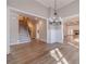 Open-concept living space featuring hardwood floors, stylish lighting, and access to other areas at 167 Pinewood Dr, Covington, GA 30014