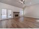 Bright living room featuring wood flooring, shiplap accent wall, and brick fireplace at 167 Pinewood Dr, Covington, GA 30014