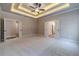 Spacious main bedroom with trey ceilings, neutral carpet, and doors leading to other rooms at 167 Pinewood Dr, Covington, GA 30014