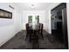 Bright dining area with stone tile floor, beadboard wainscotting and doors leading to the deck at 510 Coventry Rd # 8A, Decatur, GA 30030