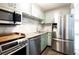 Well-equipped kitchen featuring stainless steel appliances and light green cabinetry at 510 Coventry Rd # 8A, Decatur, GA 30030