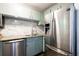 Modern kitchen with stainless steel appliances, light green cabinets, and marble backsplash at 510 Coventry Rd # 8A, Decatur, GA 30030