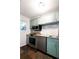 Charming kitchen with stainless steel appliances, marble backsplash, and blue-green cabinets at 510 Coventry Rd # 8A, Decatur, GA 30030