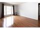 Sun-filled living room with shiny hardwood floors, neutral paint and modern black accent table at 510 Coventry Rd # 8A, Decatur, GA 30030