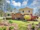 A two-story home with a backyard that includes a brick exterior and a wooden deck at 5221 La Paloma Sw Dr, Lilburn, GA 30047