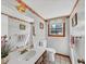 Bright bathroom featuring a wood vanity, white fixtures, and a window for natural light at 5221 La Paloma Sw Dr, Lilburn, GA 30047