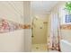 Compact bathroom featuring floral wallpaper accents, a shower, and a toilet at 5221 La Paloma Sw Dr, Lilburn, GA 30047
