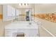 A bathroom with white cabinets, a large mirror, and decorative floral accents at 5221 La Paloma Sw Dr, Lilburn, GA 30047