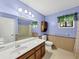Light and airy bathroom with a modern sink, wooden cabinets, and a neutral-toned shower and walls at 5221 La Paloma Sw Dr, Lilburn, GA 30047
