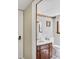 Cozy bathroom featuring a wood vanity, white sink, toilet, and decorative floral wallpaper border at 5221 La Paloma Sw Dr, Lilburn, GA 30047