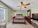 Bedroom with comfortable furnishings, a ceiling fan, and natural light from a window at 5221 La Paloma Sw Dr, Lilburn, GA 30047