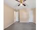 Bedroom with carpet, standard window, ceiling fan, and two entry doors at 5221 La Paloma Sw Dr, Lilburn, GA 30047