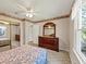 Comfortable bedroom with a dresser, mirror, closet, and a window for plenty of natural light at 5221 La Paloma Sw Dr, Lilburn, GA 30047