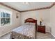 Cozy bedroom with a bed, a nightstand, carpet, and a window view of greenery at 5221 La Paloma Sw Dr, Lilburn, GA 30047