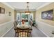 Elegant dining room with classic wainscoting, bay window, and ornate chandelier at 5221 La Paloma Sw Dr, Lilburn, GA 30047