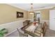 Traditional dining room showcasing a glass-top table, stylish chairs, and decorative artwork at 5221 La Paloma Sw Dr, Lilburn, GA 30047