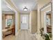 Inviting entryway features light wood floors, neutral walls, a white door, and decorative mirror at 5221 La Paloma Sw Dr, Lilburn, GA 30047