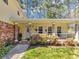 Inviting front porch with brick pillars, vinyl siding, a white railing, and manicured landscaping around the entrance at 5221 La Paloma Sw Dr, Lilburn, GA 30047