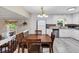Open concept kitchen featuring eat-in area, white cabinets, stainless appliances and granite countertops at 5221 La Paloma Sw Dr, Lilburn, GA 30047