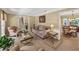 Inviting living room features plush seating, neutral walls, ample natural light, and open access to dining area at 5221 La Paloma Sw Dr, Lilburn, GA 30047