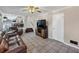 Inviting living room with tile flooring, leather sofas, and open view to the kitchen at 5221 La Paloma Sw Dr, Lilburn, GA 30047