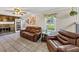 Comfortable living room showcasing a stone fireplace, leather furniture, and a cozy atmosphere at 5221 La Paloma Sw Dr, Lilburn, GA 30047