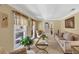Living room with plush seating, neutral walls, ample natural light, and glass-topped coffee table at 5221 La Paloma Sw Dr, Lilburn, GA 30047