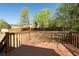 Backyard view from the deck with a wood railing and view of the fenced yard with mature trees at 6136 Marbut Rd, Lithonia, GA 30058