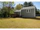 View of the backyard and deck, showing the lawn area and the back of the house at 6136 Marbut Rd, Lithonia, GA 30058