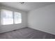 Bright, carpeted bedroom with windows for natural light at 6136 Marbut Rd, Lithonia, GA 30058