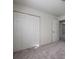 Bedroom featuring new carpet and closet space to offer comfort and functionality for modern living at 6136 Marbut Rd, Lithonia, GA 30058