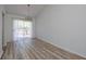 Dining area featuring wood floors, modern lighting, sliding glass doors leading to the deck, and neutral walls at 6136 Marbut Rd, Lithonia, GA 30058